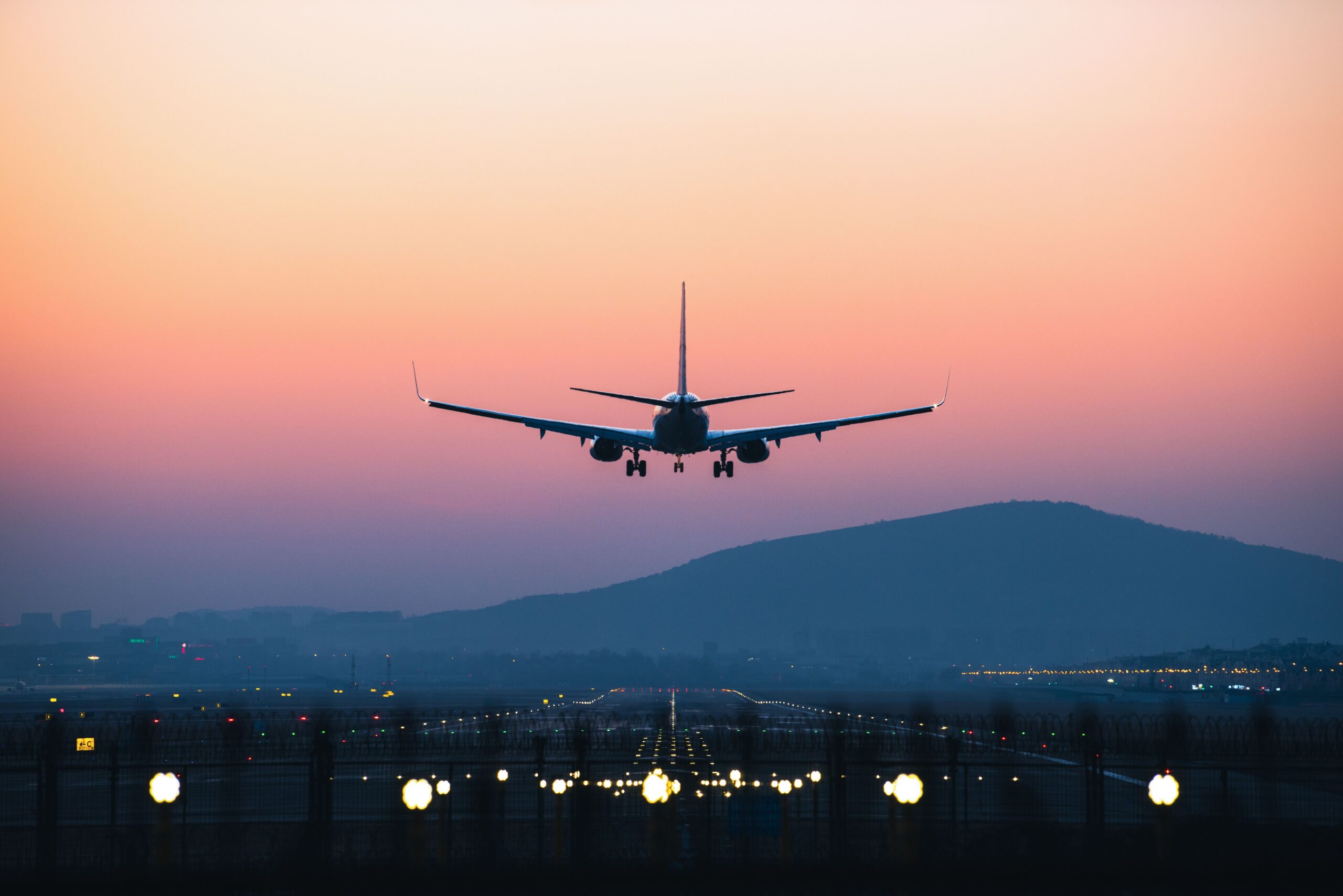 An airplane departing from airport during sunset